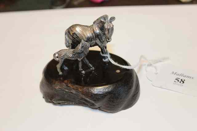 Appraisal: A SMALL WHITE METAL SCULPTURE of a zebra and her