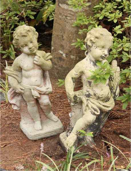 Appraisal: Pair of Cast Stone Puttiwith attractive weathering Each approximately in