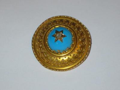 Appraisal: A VICTORIAN TARGET BROOCH with central turquoise enamel round set