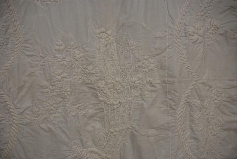 Appraisal: TRAPUNTO COVERLET th C White cotton coverlet with central cornucopia