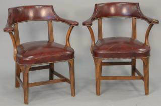 Appraisal: Pair of leather upholstered armchairs surface cracks Pair of leather