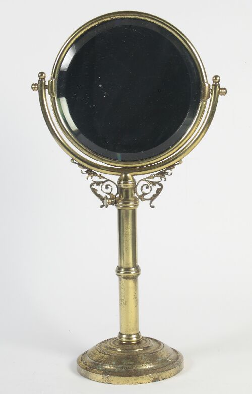 Appraisal: A th century brass shaving mirror the circular bevelled plate