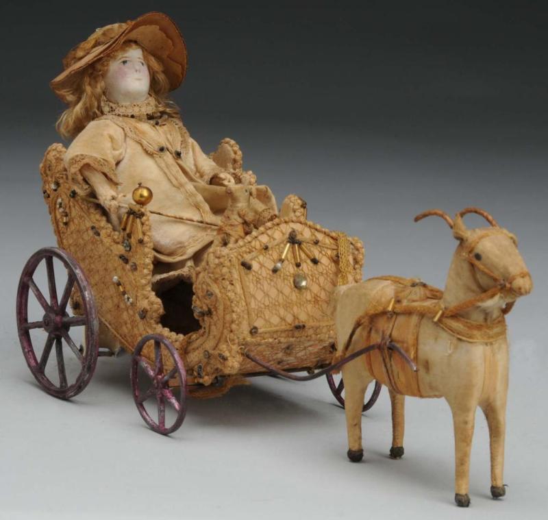 Appraisal: Lady in Goat Cart Toy Description Lady with leather face