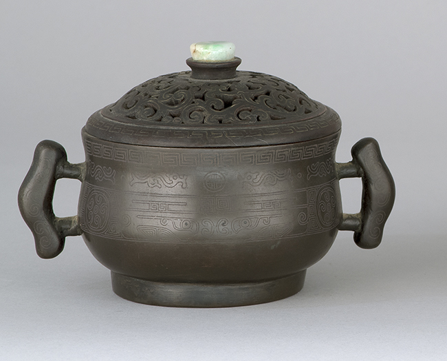 Appraisal: BRONZE CENSER Ming DynastyWith engraved archaic-style decoration modified rectangular handles