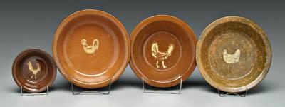 Appraisal: Four Jugtown pie dishes each with slip decorated chickens on