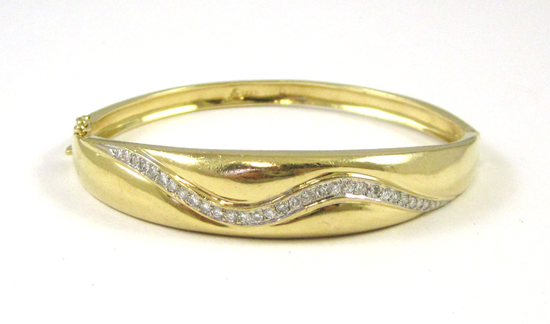 Appraisal: DIAMOND AND FOURTEEN KARAT GOLD BANGLE the wider portion featuring