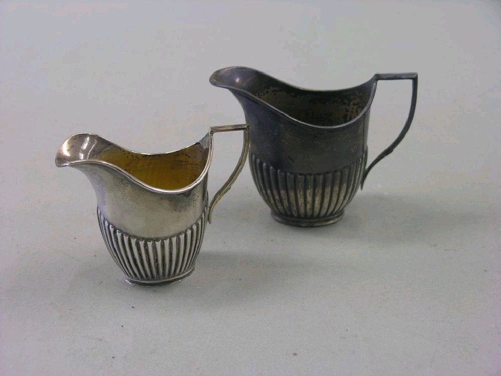 Appraisal: A silver half fluted milk jug and sugar bowl Sheffield