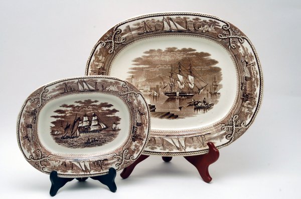 Appraisal: Two brown transferware platters in the American Marine pattern featuring