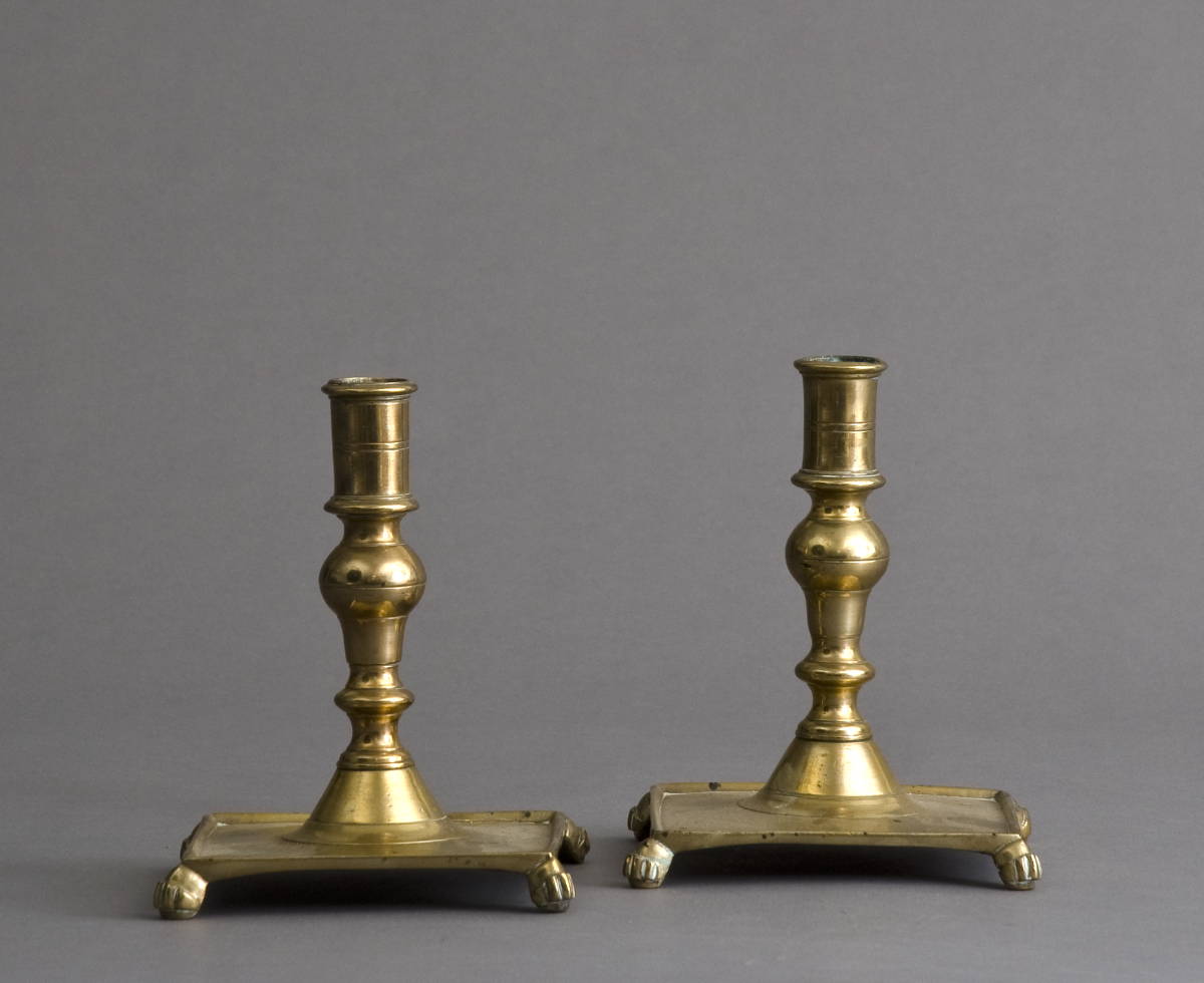 Appraisal: PAIR OF EARLY CONTINENTAL BRASS CANDLESTICKS WITH SQUARE BASES RAISED