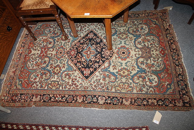 Appraisal: A CAUCASIAN IVORY GROUND RUG with central blue medallion and