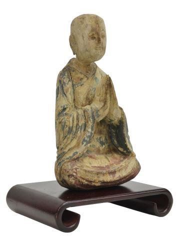 Appraisal: Chinese carved wood Buddha seated in Anjali Mudra with remnants