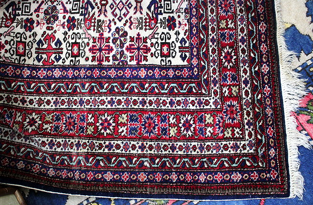 Appraisal: AN ORIENTAL CREAM GROUND RUG the central field with five