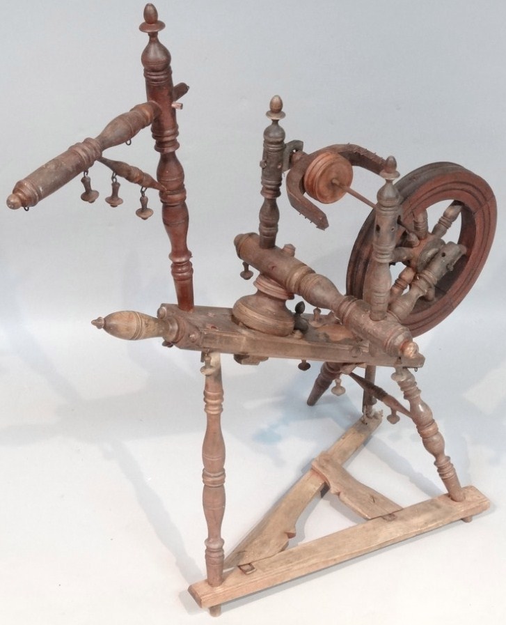 Appraisal: An early thC elm spinning wheel with articulated circular wheel