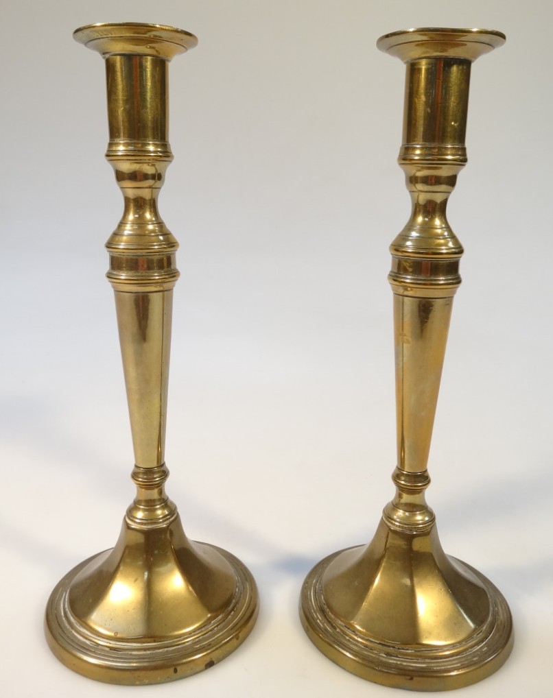 Appraisal: A pair of thC brass candlesticks each with cylindrical dish