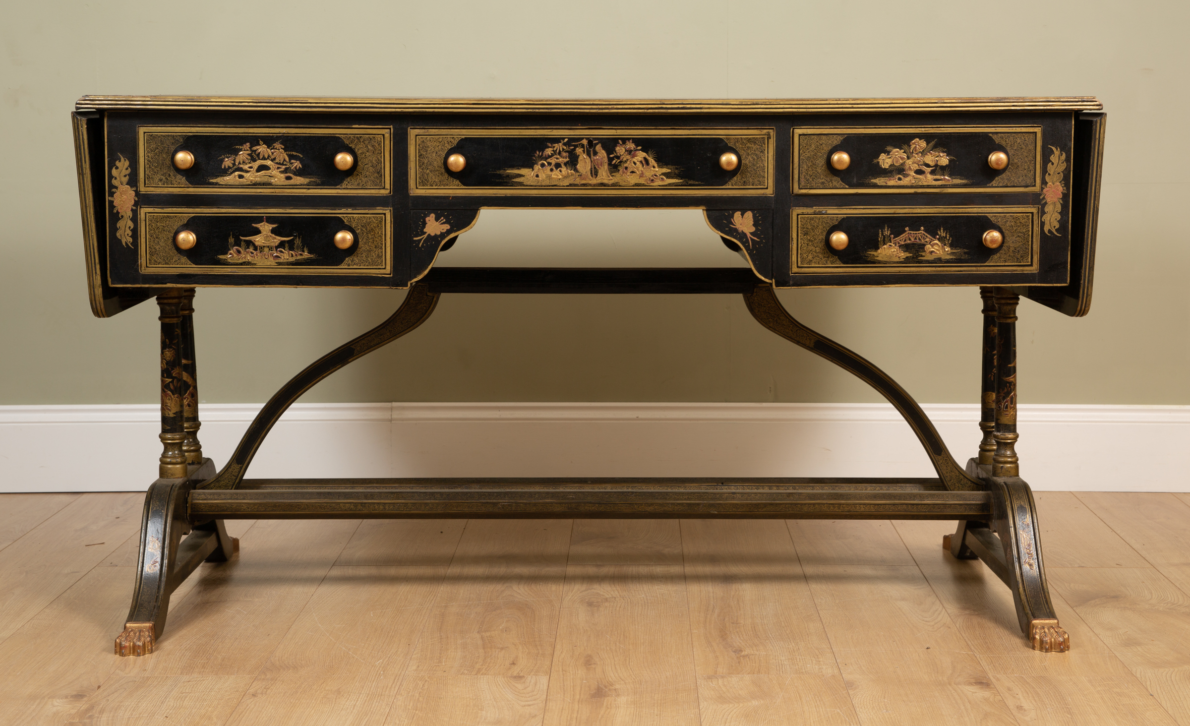 Appraisal: A Georgian-style black lacquered chinoiserie decorated writing desk with green