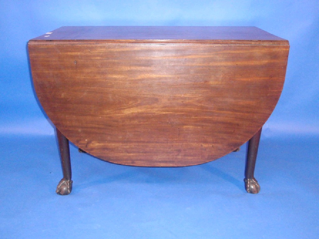 Appraisal: A Georgian mahogany drop leaf dining table raised on ball