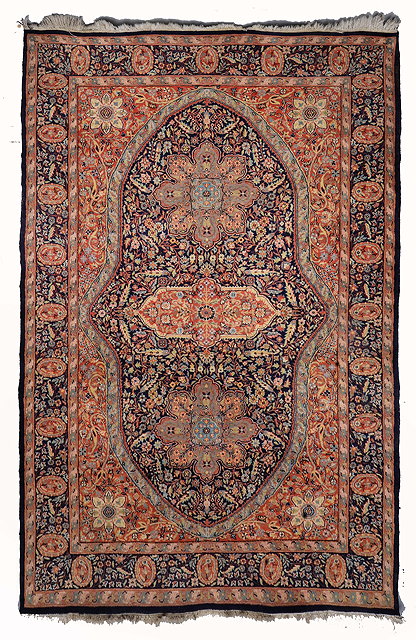 Appraisal: AN INDIAN PERSIAN PATTERN RUST GROUND RUG decorated a central