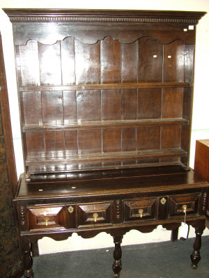 Appraisal: A Victorian oak dresser the dentil moulded cornice above three