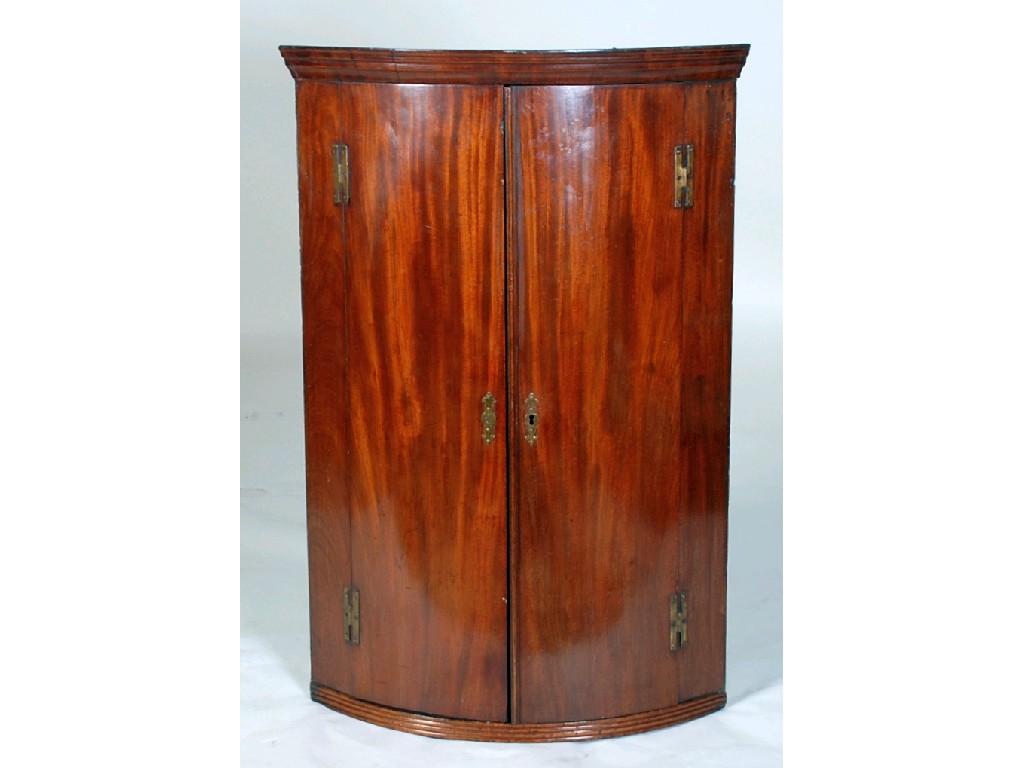 Appraisal: GEORGIAN MAHOGANY WALL HANGING BOW FRONT CORNER CUPBOARDS with moulded