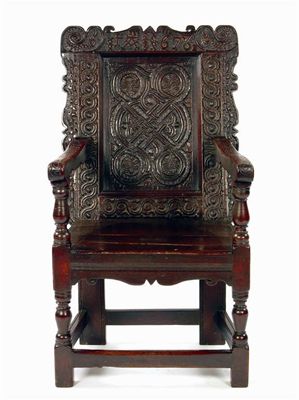 Appraisal: A Charles II carved oak panel back open armchair the