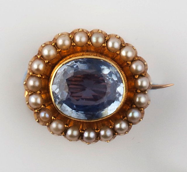 Appraisal: A SAPPHIRE AND HALF PEARL BROOCH the oval mixed-cut sapphire