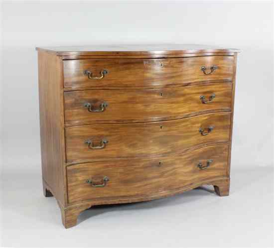 Appraisal: A George III mahogany serpentine chest of four graduated long