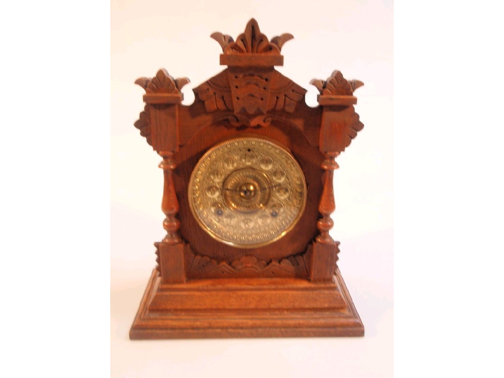 Appraisal: An Edwardian oak mantel clock with pressed brass dial and