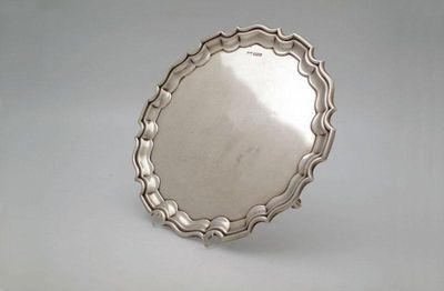 Appraisal: A silver salver by Walker and Hall Sheffield circular form