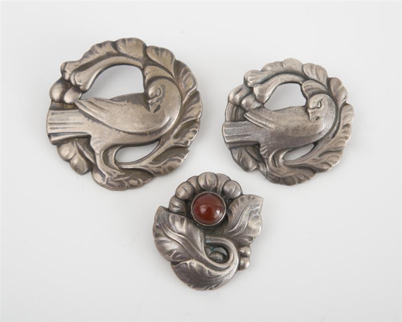 Appraisal: THREE DANISH STERLING SILVER PINS Modeled with birds one set