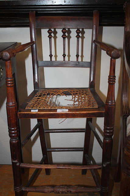 Appraisal: A VICTORIAN ASH AND BEECH CHILD'S HIGHCHAIR with spindle back