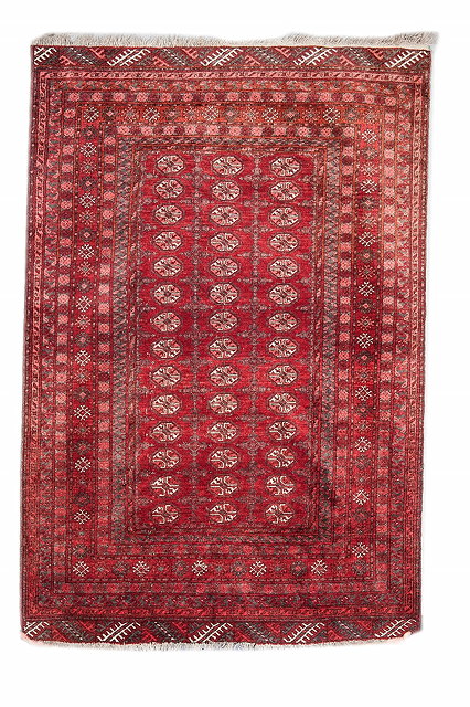 Appraisal: AN AFGHAN WINE GROUND RUG decorated three rows of medallions