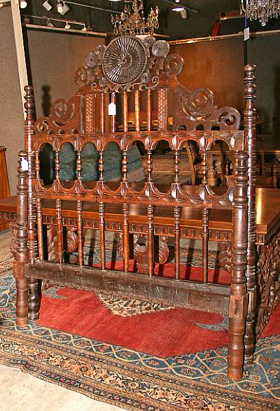 Appraisal: A Spanish Baroque style walnut headboard and footboard height ft