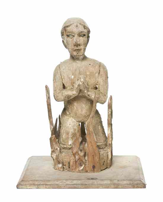 Appraisal: A Folk Art Carved Figure depicting a praying figure surrounded