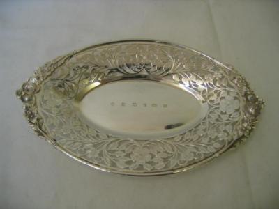 Appraisal: A SWEETMEAT DISH of oval form with flower moulded handle