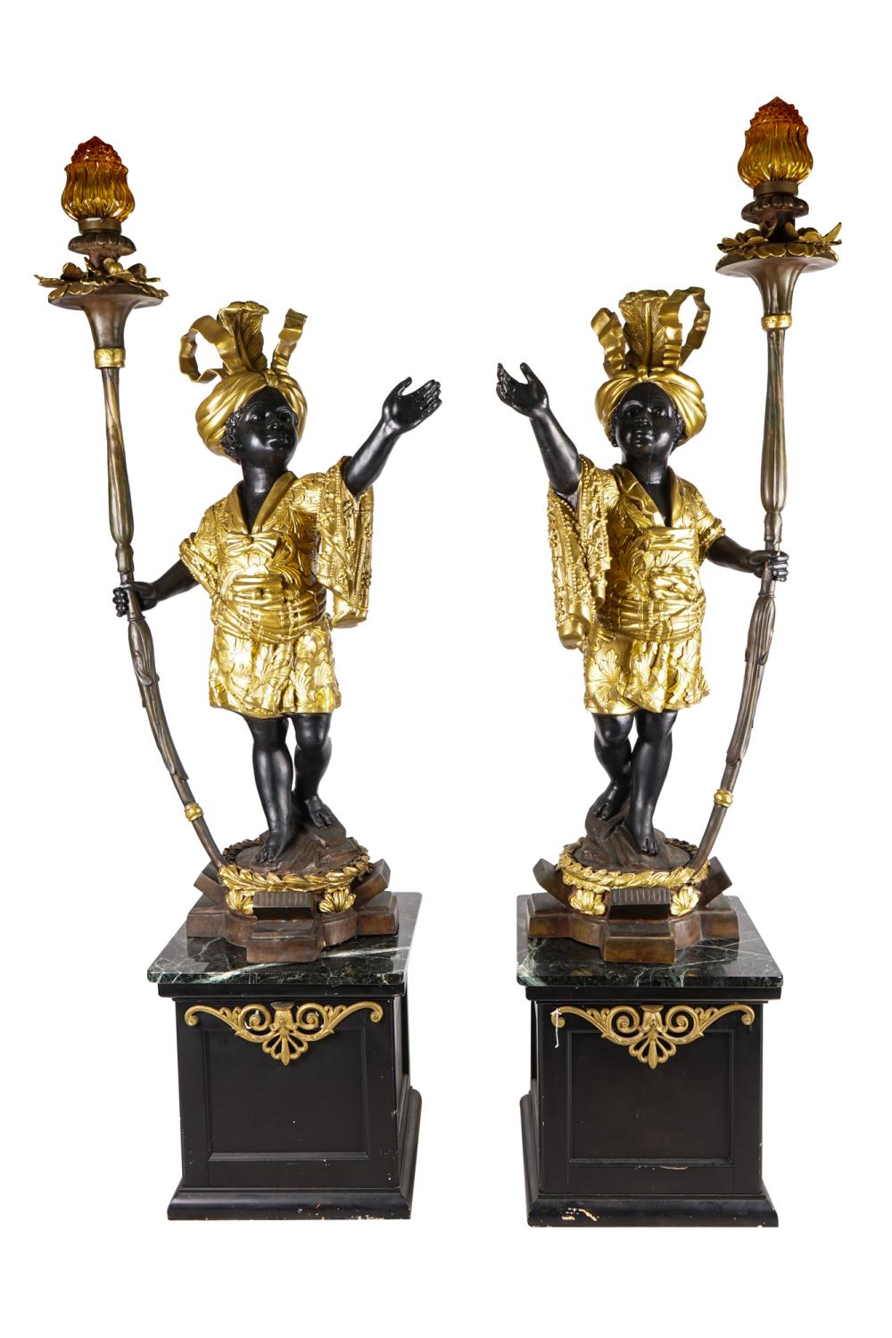 Appraisal: PAIR OF GILT PATINATED BRONZE FIGURAL TORCHERESeach resting on a