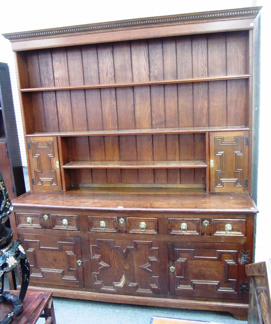 Appraisal: A large oak dresser the enclosed three tier plate rack