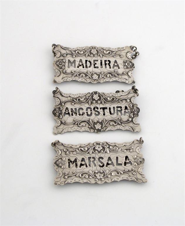 Appraisal: A set of three silver wine labels