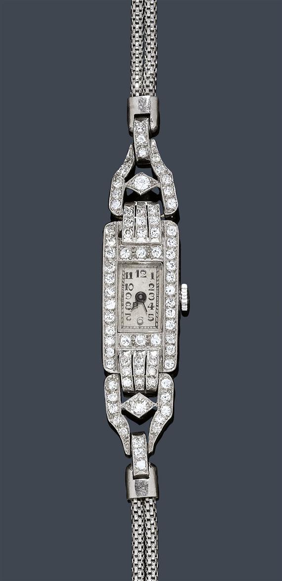 Appraisal: DIAMOND LADY'S WRISTWATCH ca Platinum Rectangular lateral florally engraved case