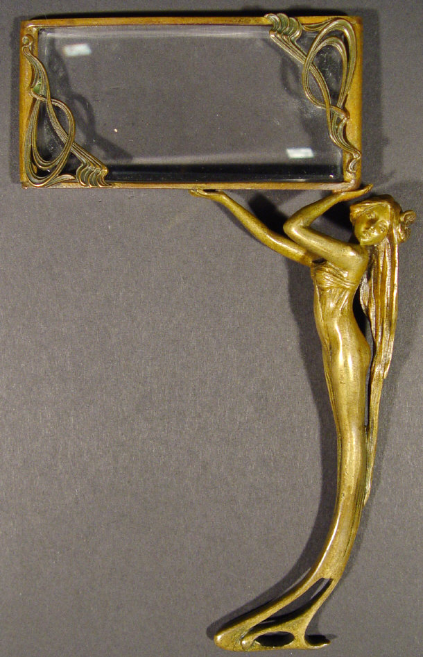 Appraisal: Art Nouveau brass magnifying glass with a stylised figural handle