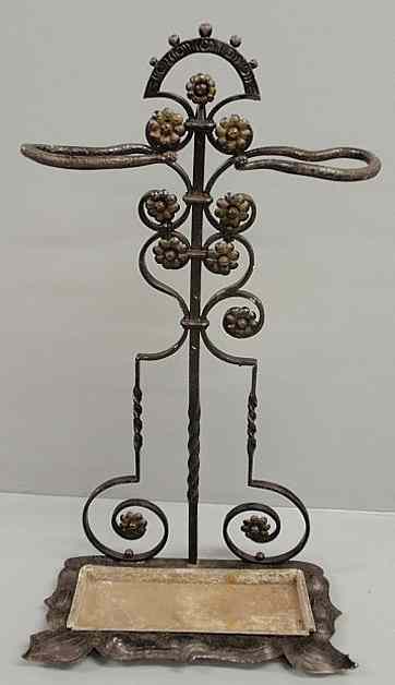 Appraisal: Victorian wrought iron umbrella stand with rosette and snake decoration