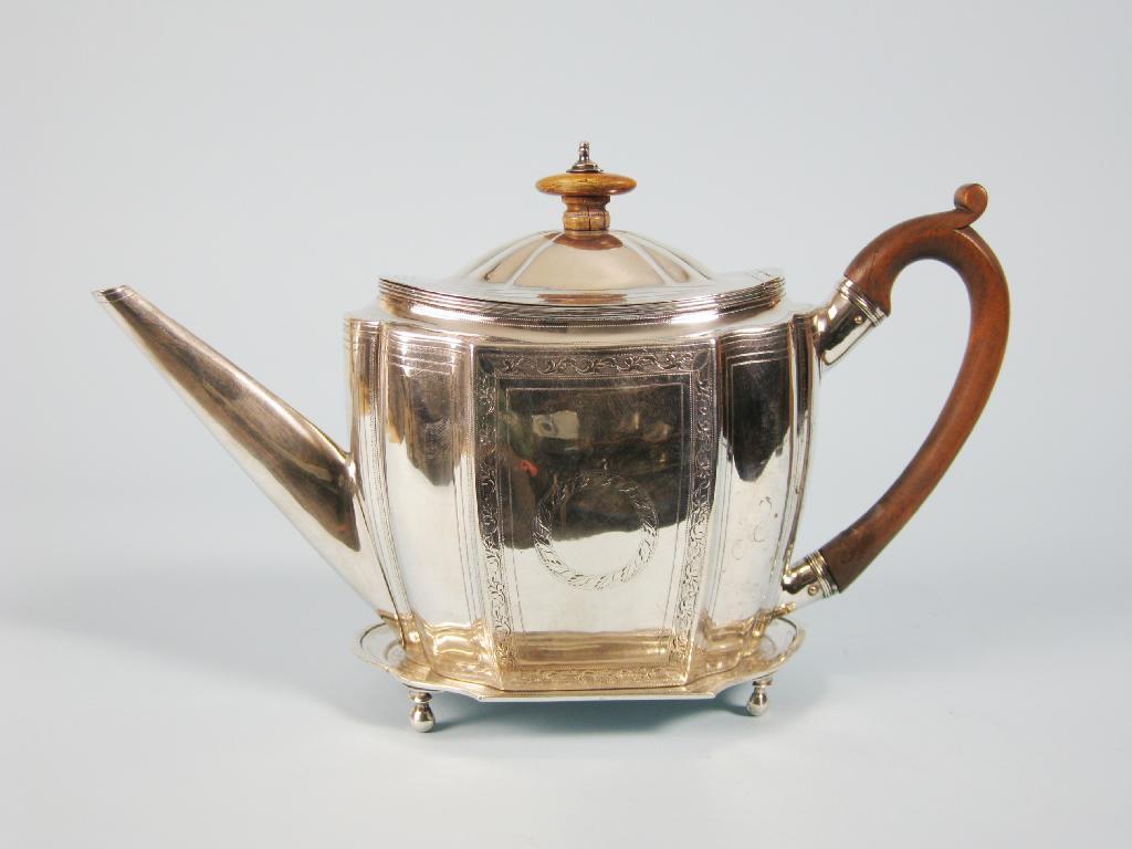 Appraisal: A George III shaped oval Teapot and Stand engraved leafage