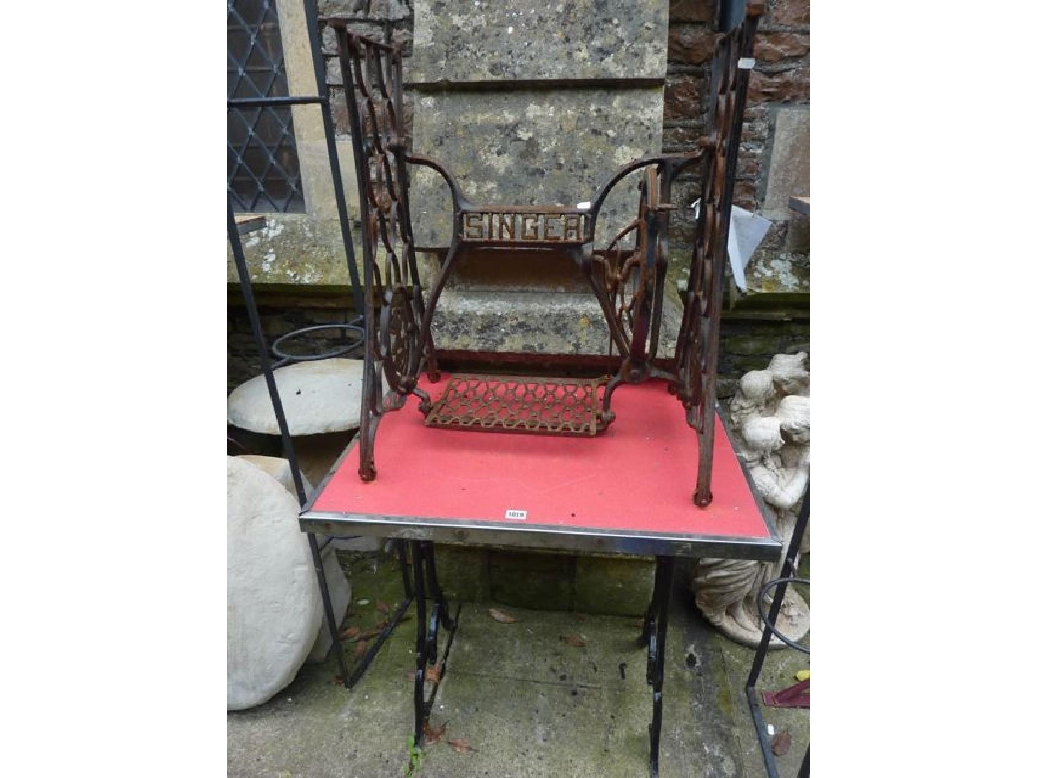 Appraisal: A small cast iron table base with shaped supports beneath