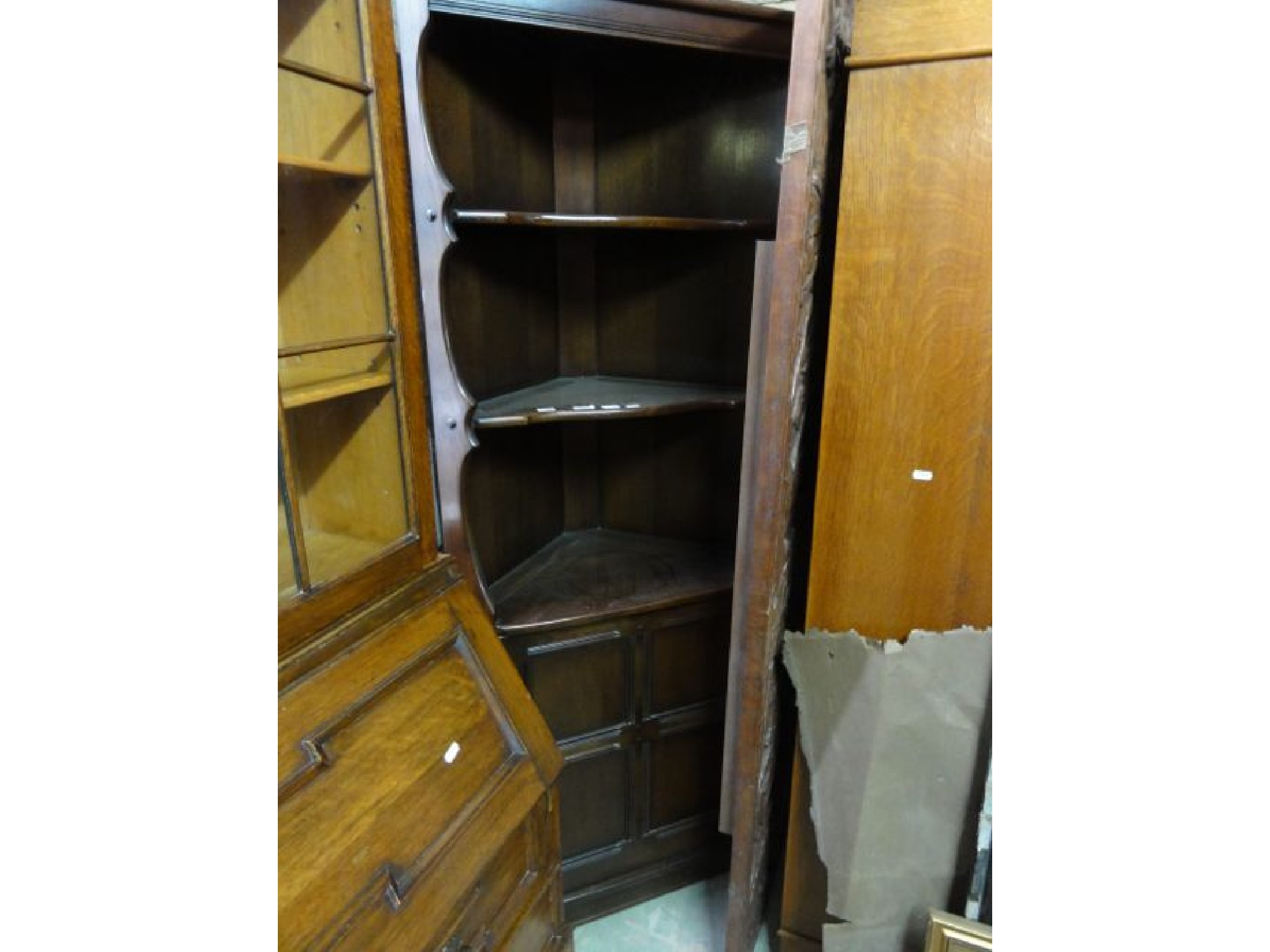 Appraisal: An Ercol dark elm freestanding corner cupboard the lower section