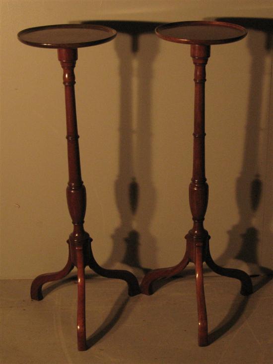 Appraisal: Pair of early twentieth century mahogany torcheres on turned column