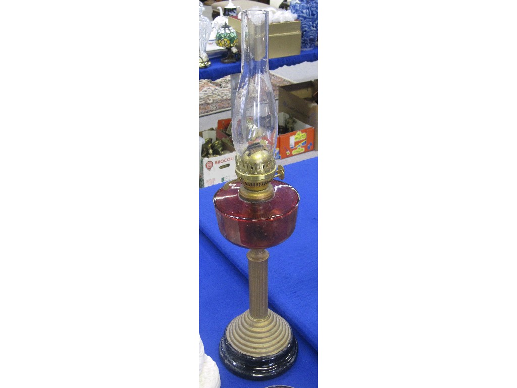 Appraisal: Corinthian column paraffin lamp with cranberry glass reservoir