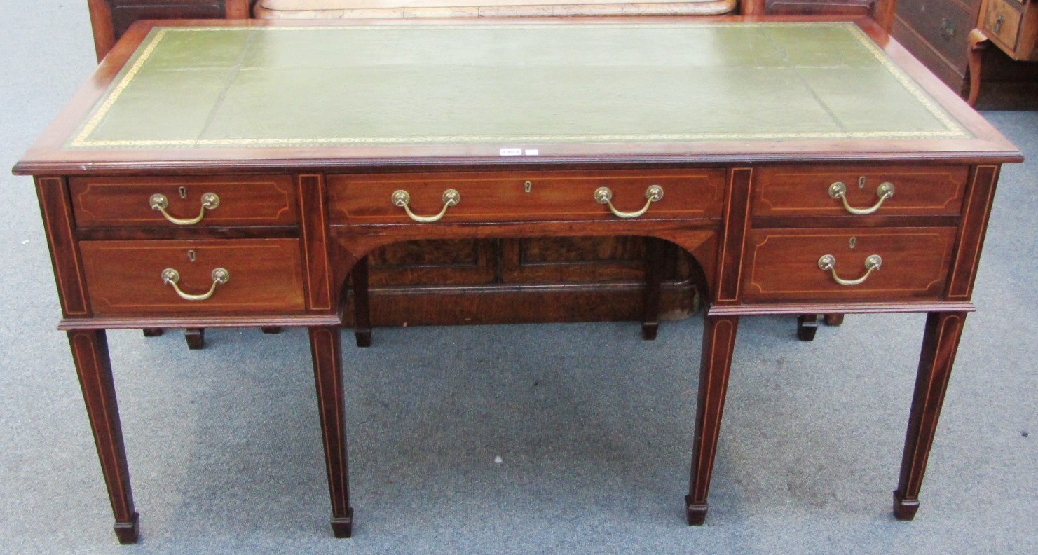 Appraisal: A th century mahogany five drawer writing desk on tapering