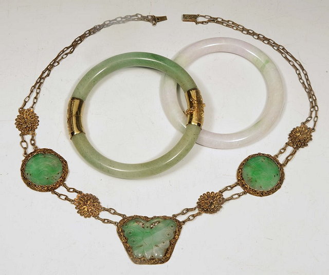 Appraisal: A CHINESE GREEN JADE BANGLE one other bangle and a