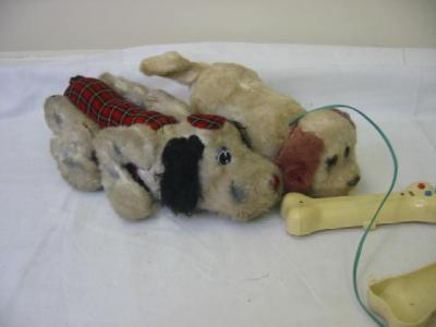 Appraisal: A tin plate and fur covered barking dog toy in