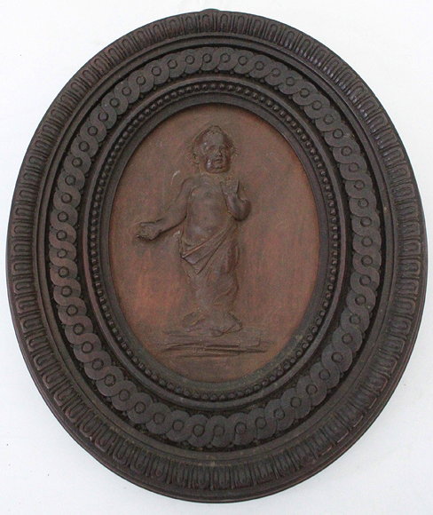 Appraisal: AN ANTIQUE CARVED WOODEN OVAL RELIEF DEPICTING A PUTTI in