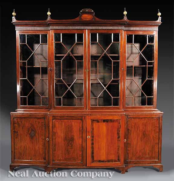 Appraisal: A George III Carved Mahogany Breakfront Bookcase pedimented cornice with